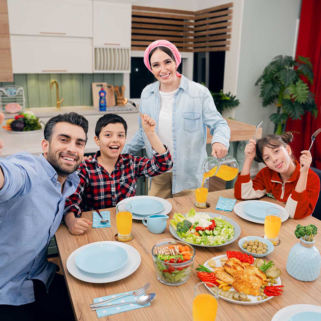 A family of four seated at a table for dinner