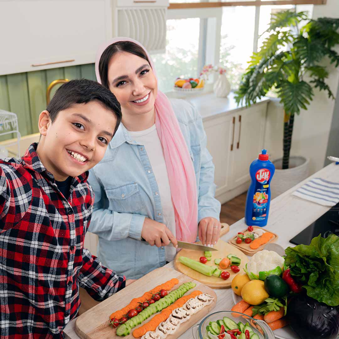 A mother and son cooking in the kitchen