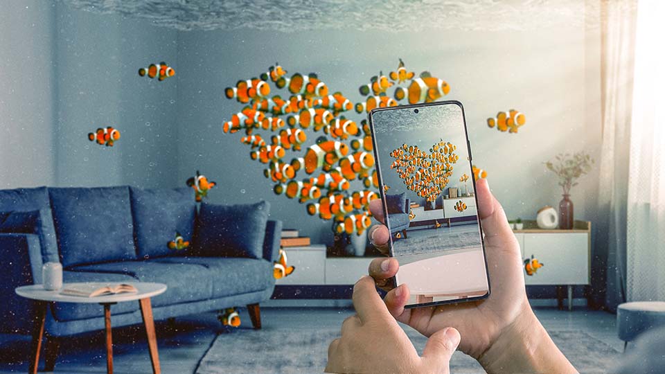 no-borders-with-nature-fish A school of clownfish forming a heart shape in a living room - a hand is seen photographing them with a Samsung phone